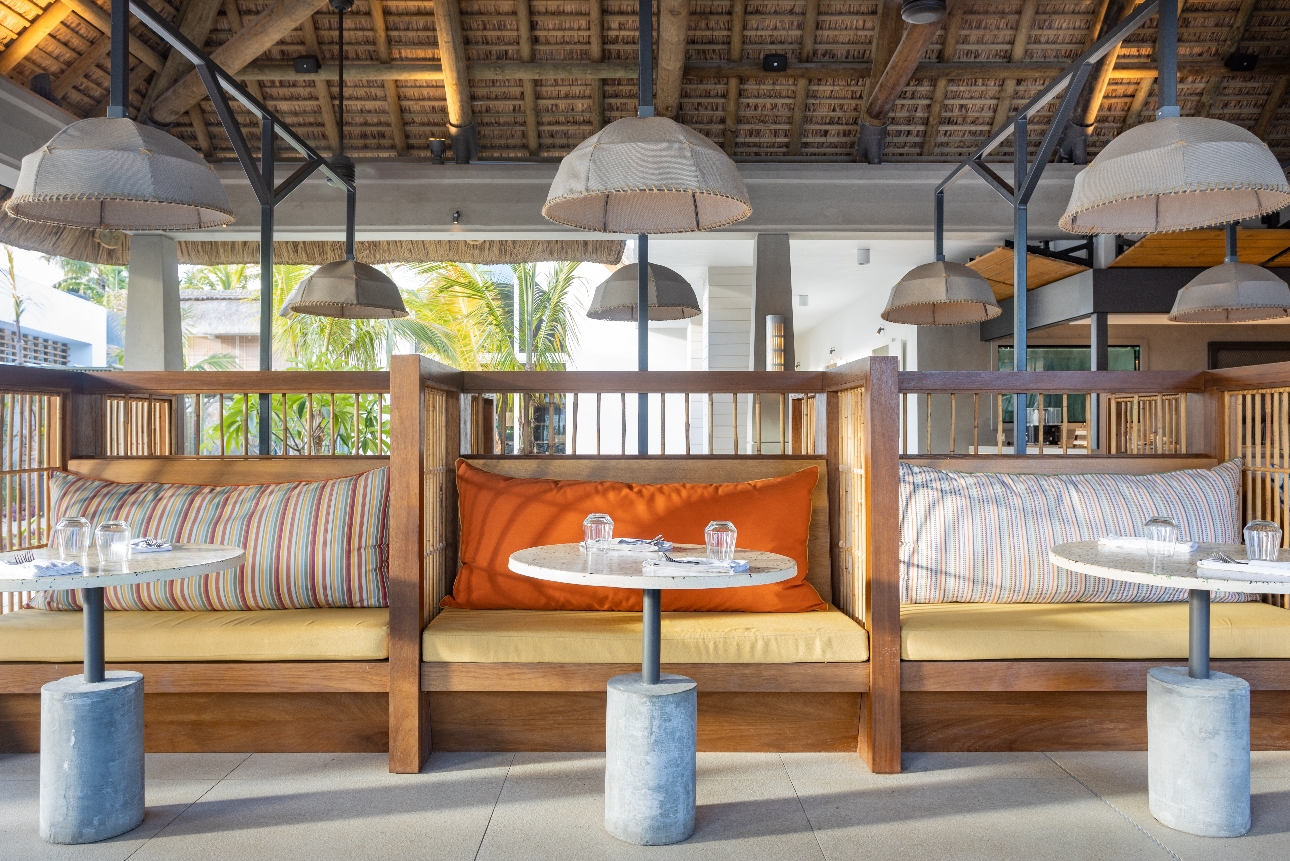 restaurant sofa chairs with rattan backs looking out to sea