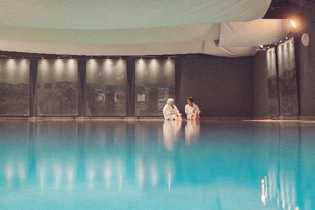 two people on the edge of a spa pool