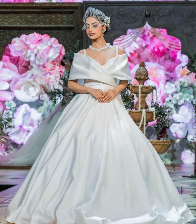 model on catwalk in wedding dress with classic cross over top neckline