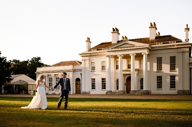 bridal couple outside white house with columns