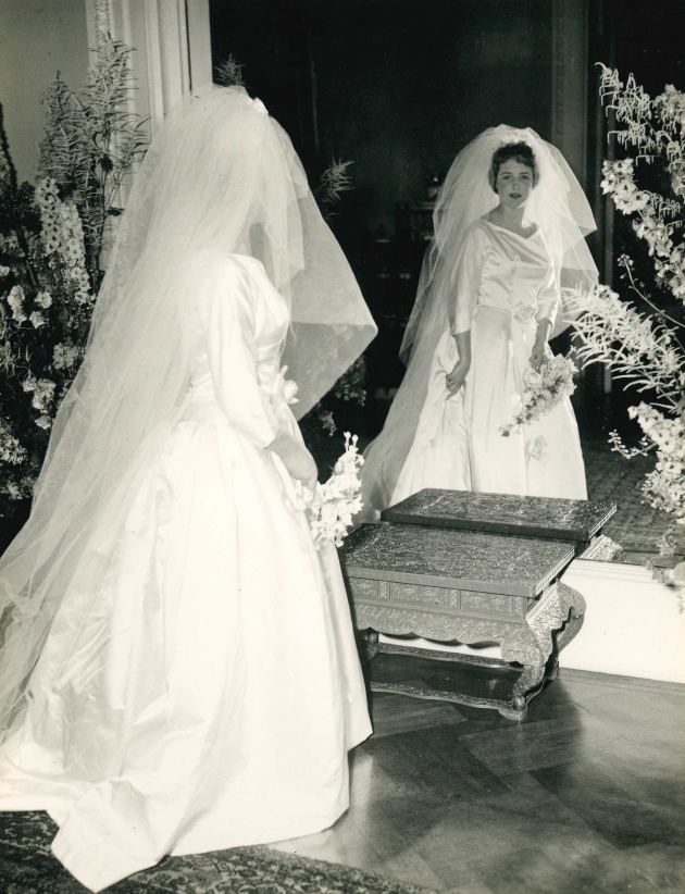 black and white image of a bride looking at her reflection in mirror