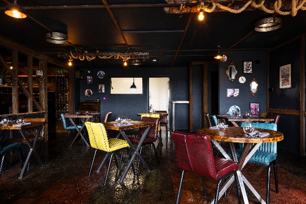 dark restaurant interior with bright leather chairs