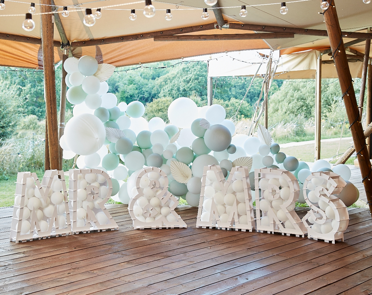 Mr and Mrs Letter on a dance floor with balloons in them