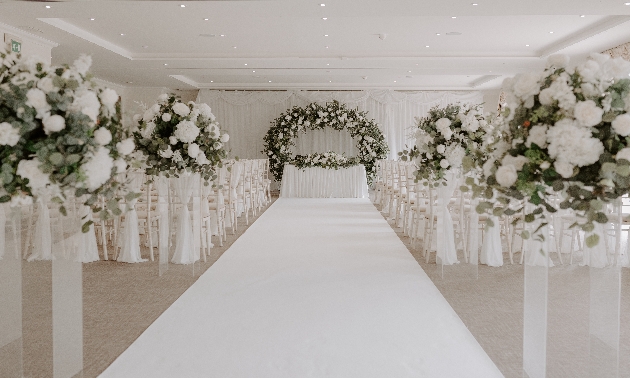 wedding set up with white aisle and white flowers