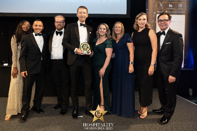 group of people wearing black tie holding an award