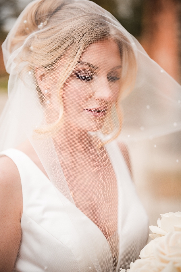 soft focus shot of bride with blonde hair wearing veil