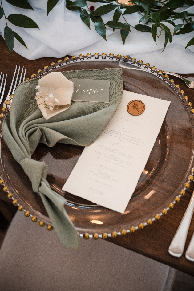 wedding table setting with sage green napkin