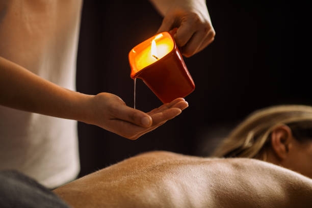 candle being used in massage at a spa